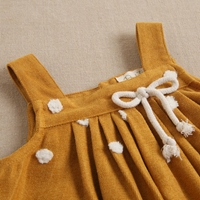 Imagen de Pichi de bebé niña pana mostaza con pompones blancos 