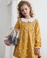 Imagen de Vestido de niña pana mostaza con  pompones blancos 